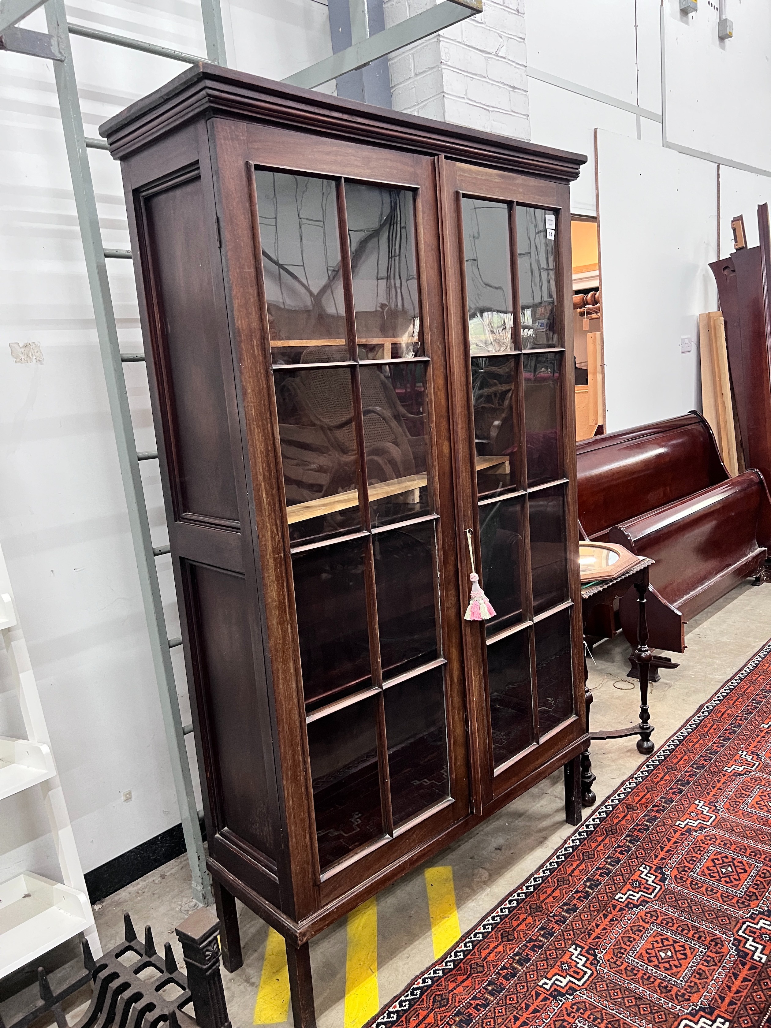 A George III mahogany glazed two door bookcase, width 112cm, depth 38cm, height 188cm, *Please note the sale commences at 9am.